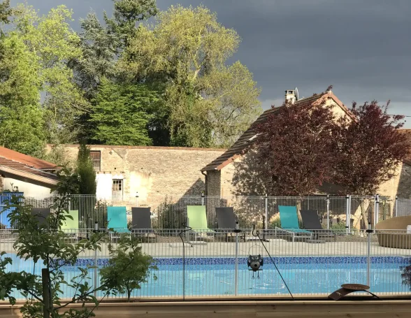 Vue de la piscine sous un ciel orageux avec chaises longues Vue de la piscine sous un ciel orageux avec chaises longues