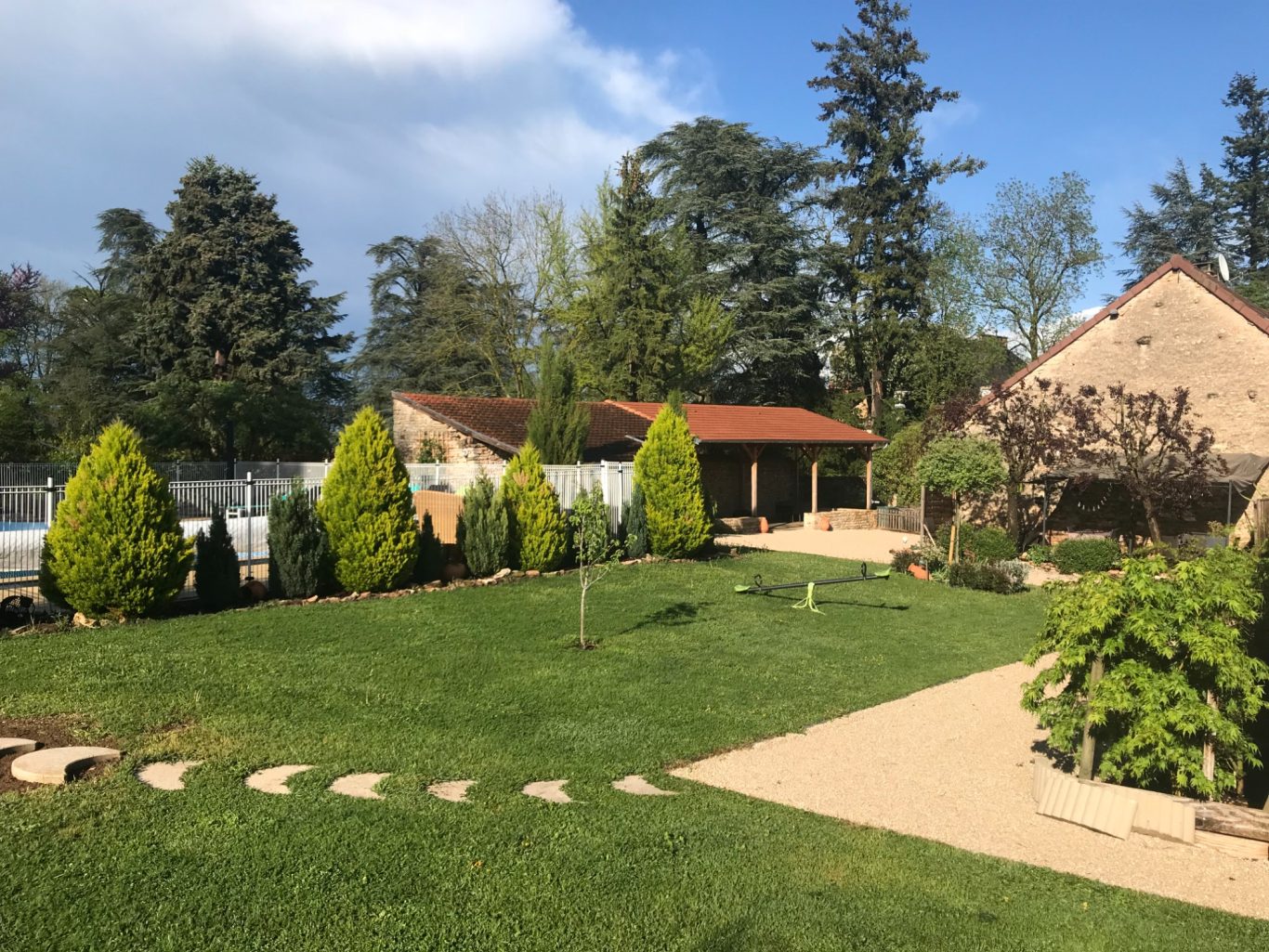 Vue du jardin, sur piscine et au fond espaces de repos des gîtes